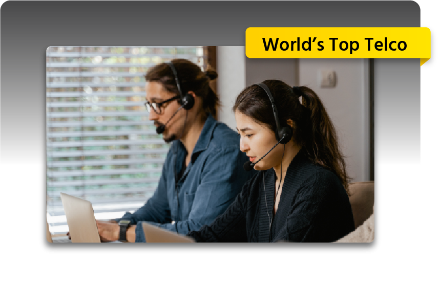 Two people working in a call center with headsets