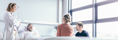 Patient surrounded by doctor and family