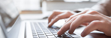 Person typing on computer keyboard