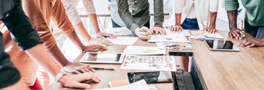 Marketing team around table reviewing assets