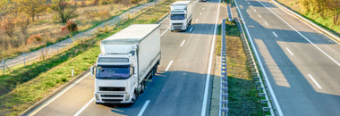 Two trucks driving on highway