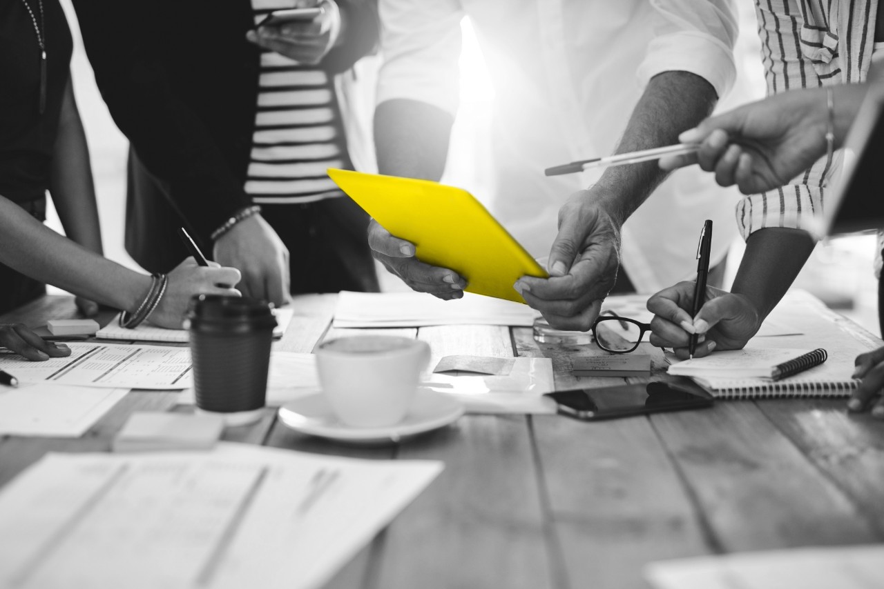 Shot of a group of unrecognizable people working together in a modern office