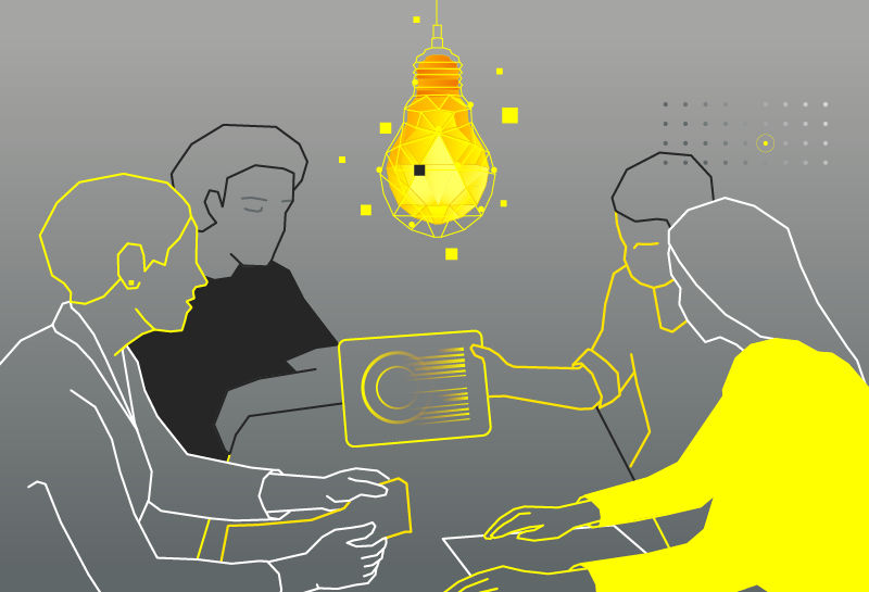 Group of business people brainstorming at a creative office and a light bulb in the foreground